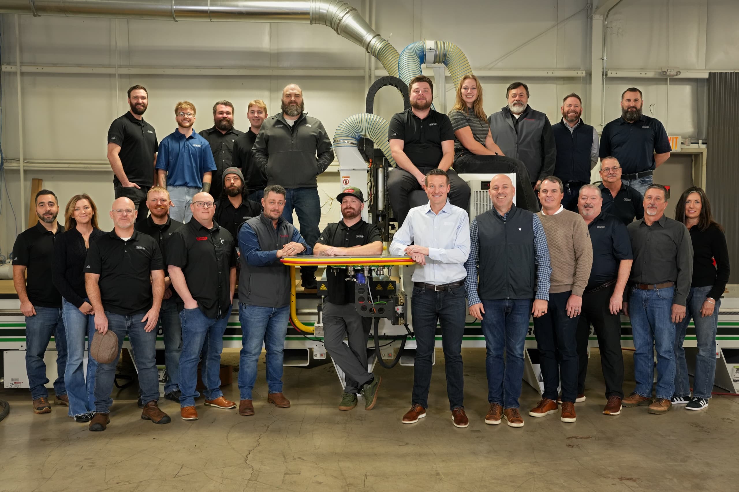 The full Scarlett team gathered around a C.R. Onsrud CNC router